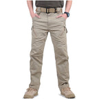 Man wearing khaki cargo trousers with multiple pockets, front view