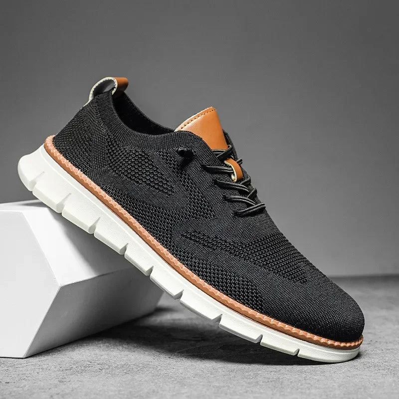 Men's black textured lace-up shoe with brown sole, side view