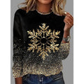 Woman wearing a black Christmas sweater with a large gold snowflake design
