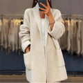 Women's chunky ribbed cardigan with shawl collar and patch pockets in cream – front view