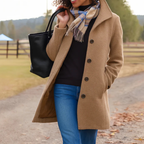 Woman wearing a khaki button front winter coat outdoors