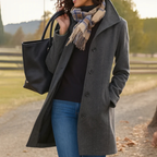 Woman in a dark gray button front winter coat with scarf