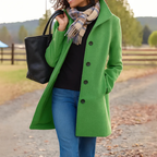 Woman wearing a bright green long winter coat