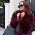 Women's cropped faux fur jacket with V neckline in burgundy – front view