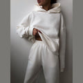 Women's hooded sweatshirt and jogger set in white – front view