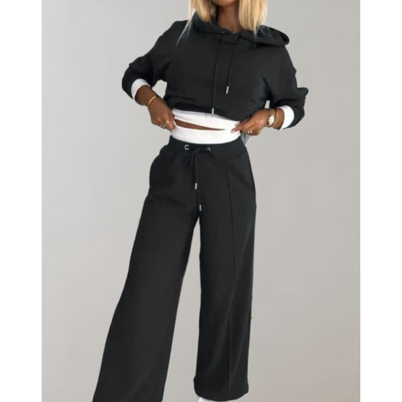 Woman wearing a black hoodie and wide jogger set