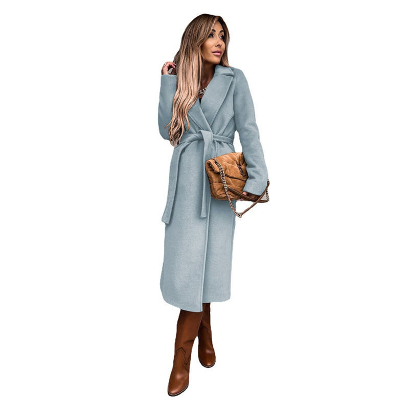 Women's long belted coat with lapel collar in sky blue – front view