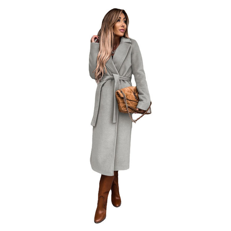 Women's long belted coat with lapel collar in light gray – front view