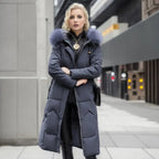 Woman wearing a dark gray long quilted puffer coat