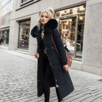 Woman wearing a black long quilted puffer coat with bag