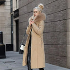 Woman in a khaki long quilted puffer coat, side view