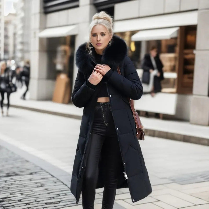Woman wearing a black long quilted puffer coat with plush trim hood