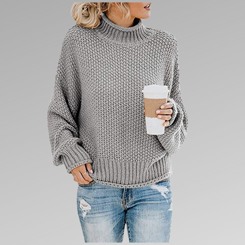 Woman wearing a gray loose knit sweater