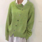 Women's oversized cardigan with asymmetric buttons in green – front view