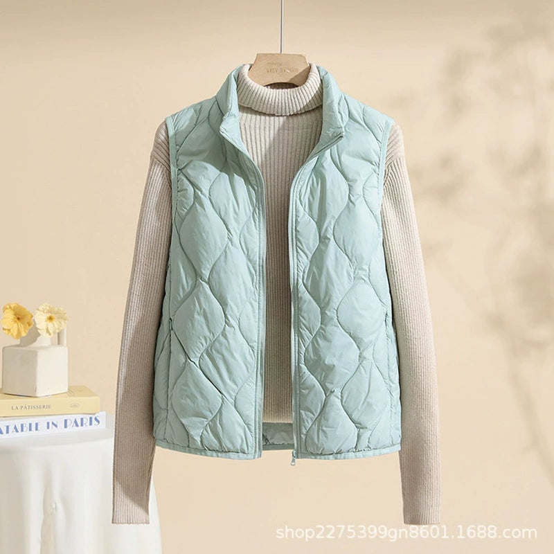 Women's quilted vest with stand collar in mint green – front view