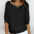 Woman wearing a black textured knit sweater