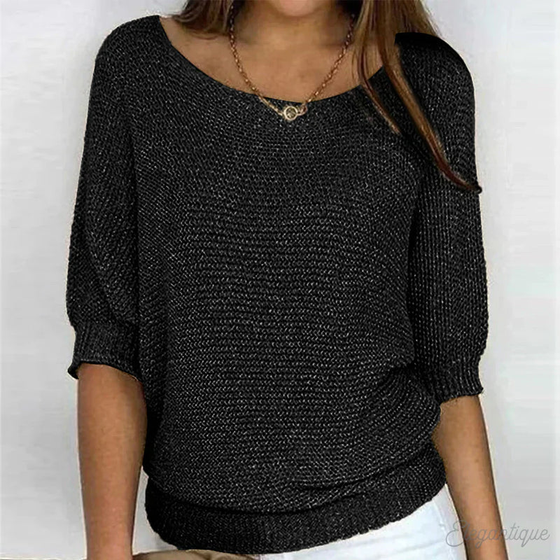 Woman wearing a black textured knit sweater
