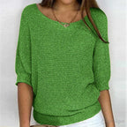 Woman in a green textured knit sweater