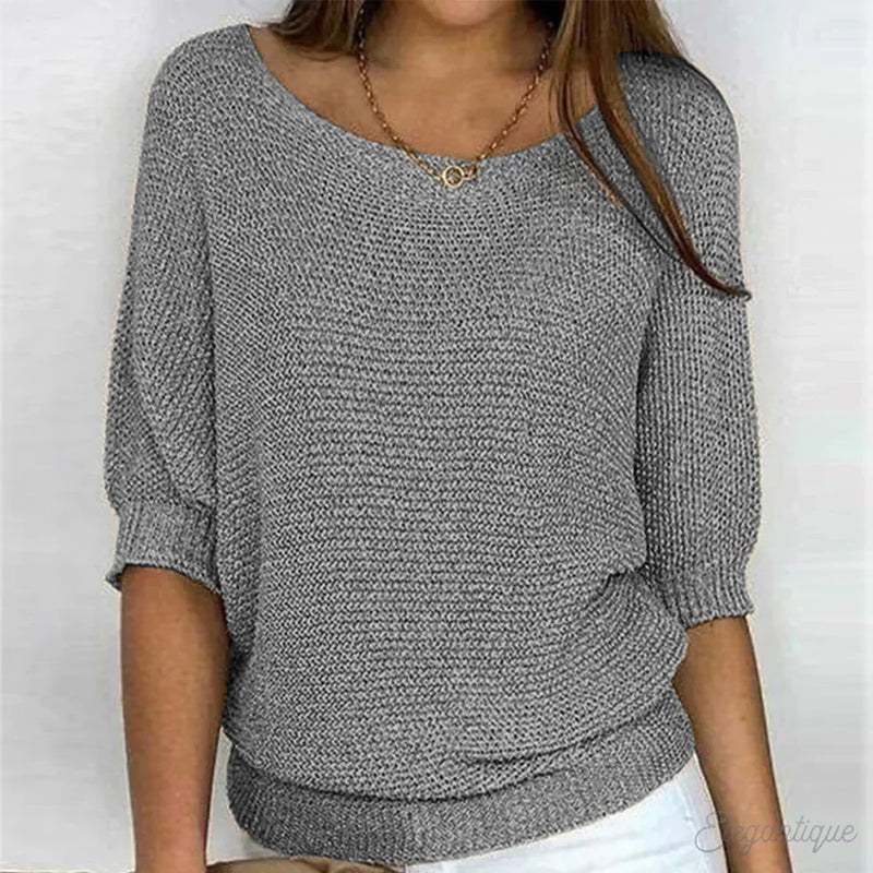 Woman wearing a gray textured knit sweater