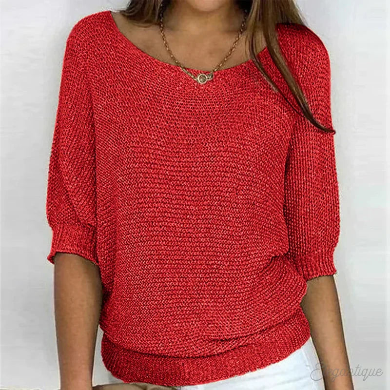 Red textured knit sweater worn with jeans