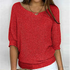 Red textured knit sweater worn with jeans