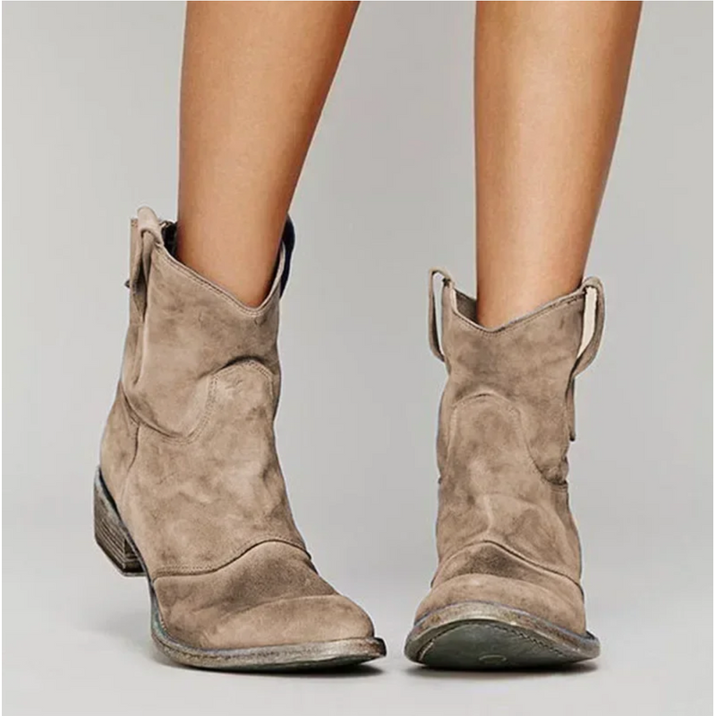 Brown western ankle boots with low heel worn with jeans